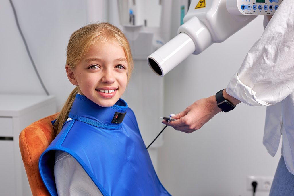 Young,Child,Girl,Next,To,Dental,3d,X-ray,Digital,Scanner