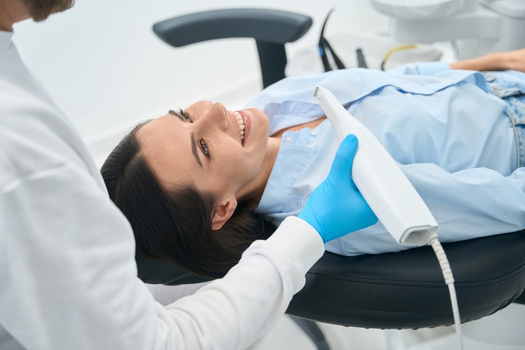 Woman,Lying,In,Orthodontic,Chair,,Preparing,For,Check-up,With,Intraoral