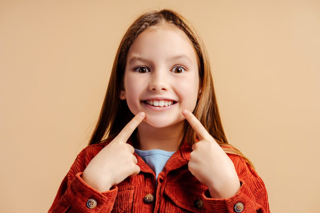 Portrait,Of,Cute,Little,Girl,Wearing,Casual,Clothes,,Pointing,Finger