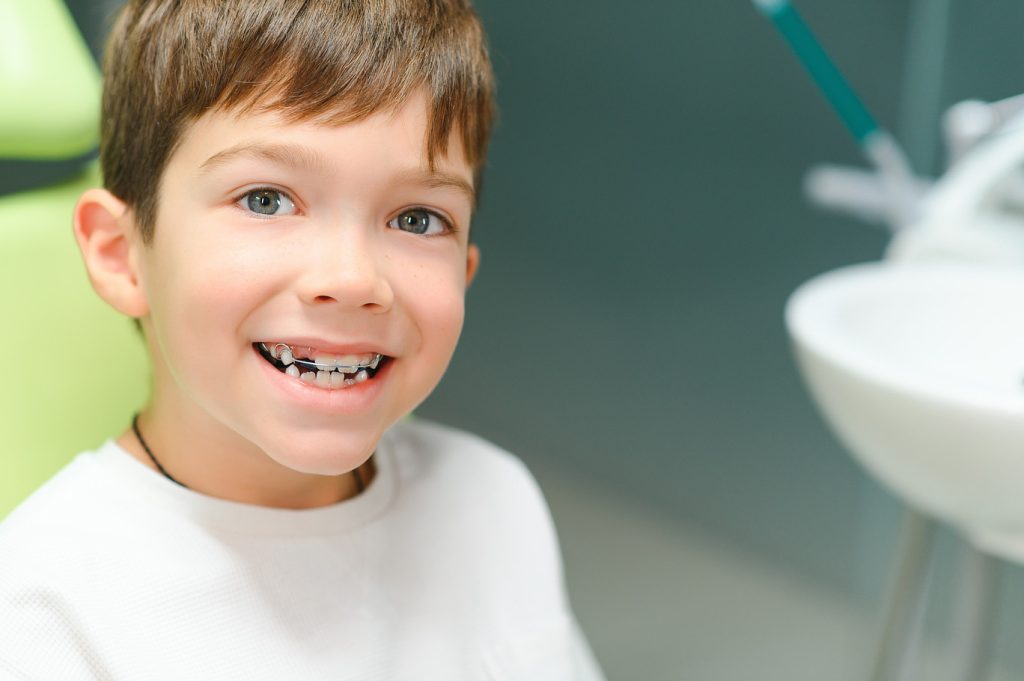 The,Boy,Inserts,An,Orthodontic,Plate,In,His,Mouth.