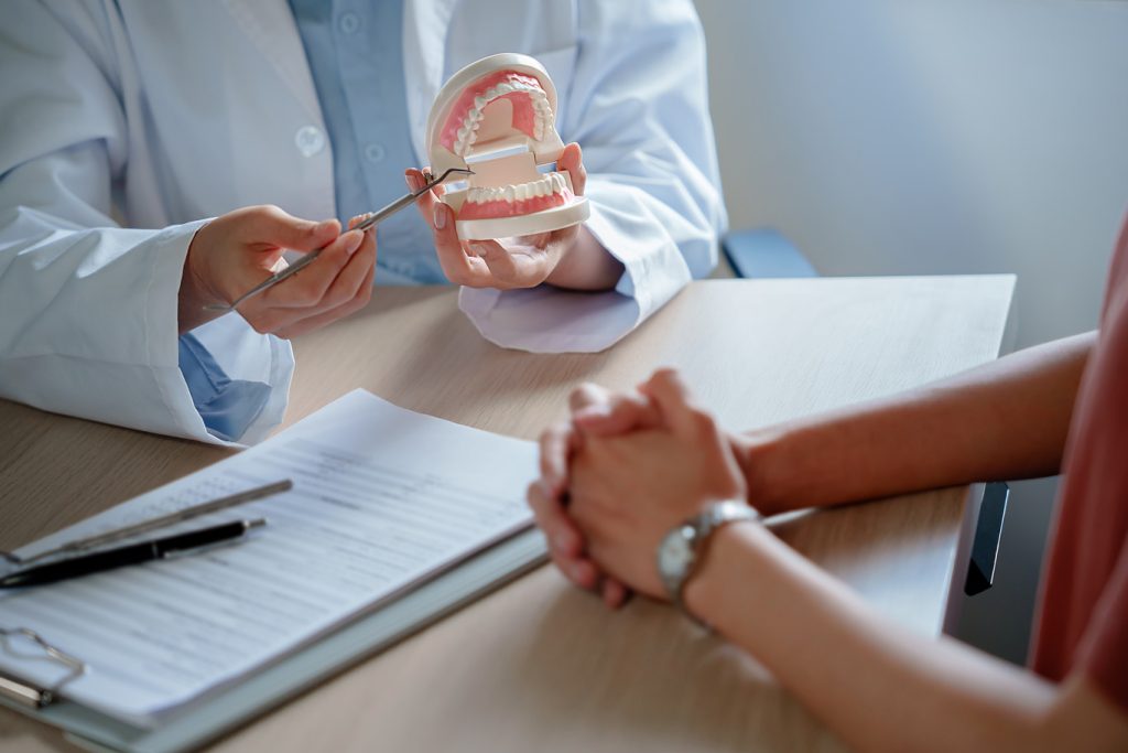 Dentist,Holding,Tooth,Model,White,Healthy,Tooth,Doctor,Doing,Dental