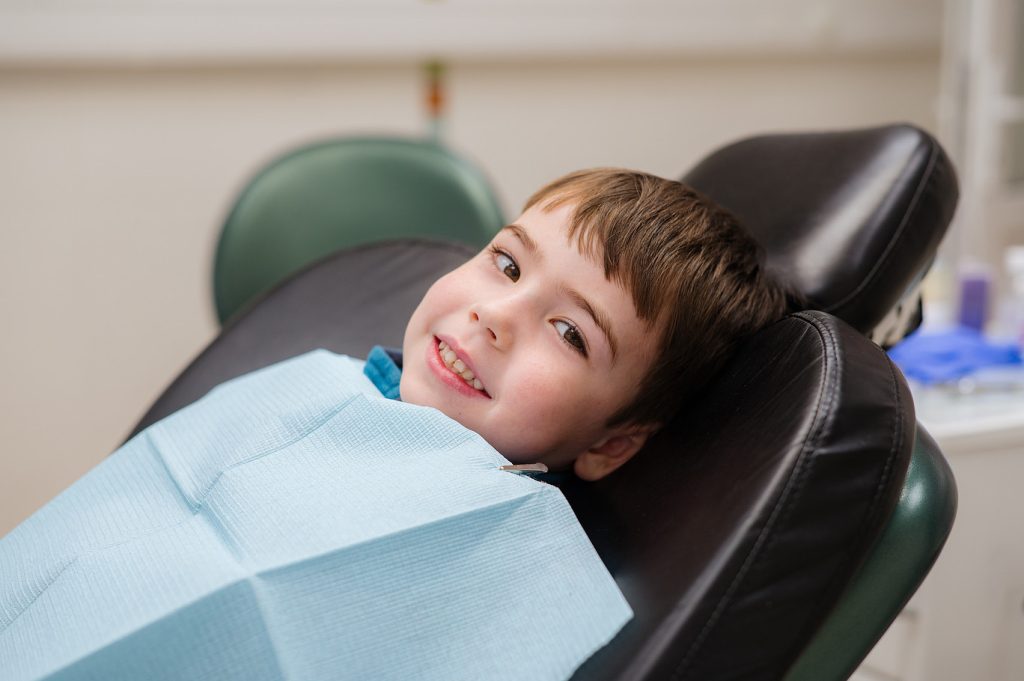 A,Cute,Little,Boy,In,A,Dental,Chair,Treats,His