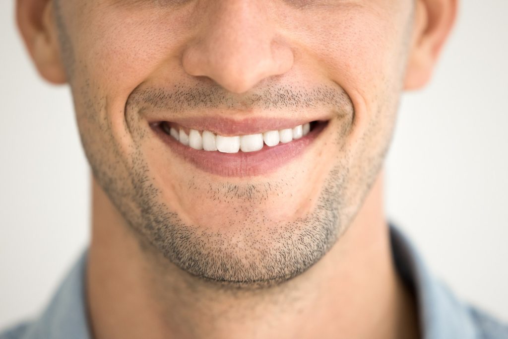 Close,Up,Of,Male,Toothy,Smile,,Shaved,Chin,With,Stubble,