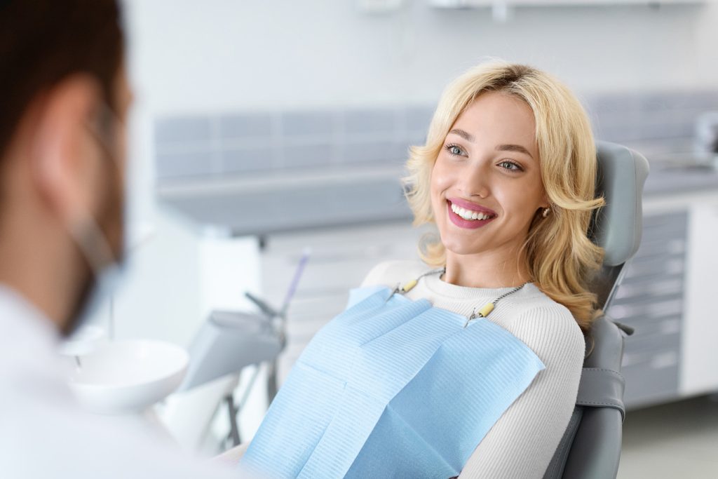 Relaxed,Blonde,Woman,Smiling,To,Her,Dentist,,Side,View,,Copy
