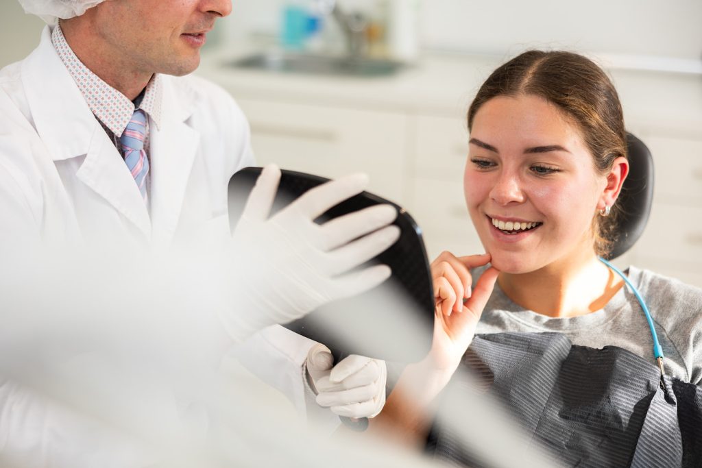 Adult,Male,Dentist,Showing,Young,Female,Patient,Result,Of,Dental
