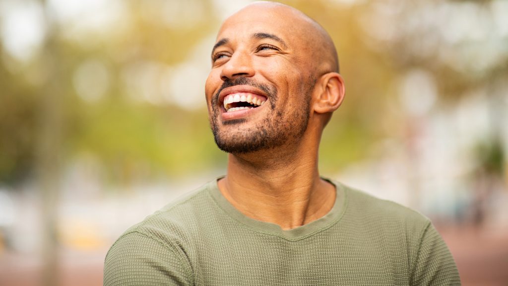 Close,Up,Portrait,Bearded,,Bald,Man,Laughing,And,Looking,Away