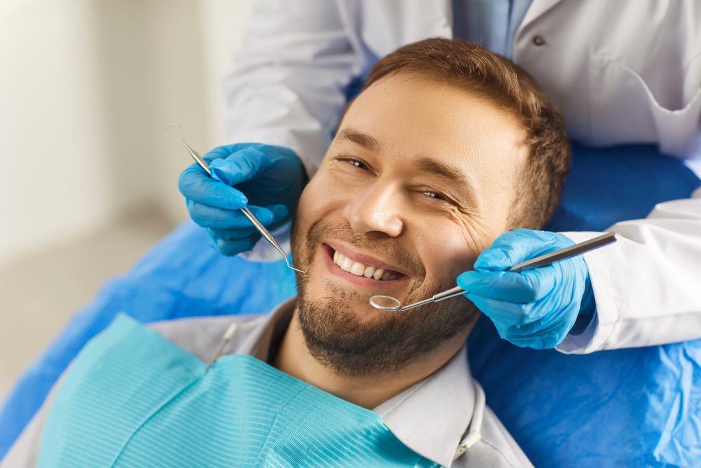 Dental,Health.,Man,Sits,Comfortably,In,Dentists,Chair,,Showing,Off