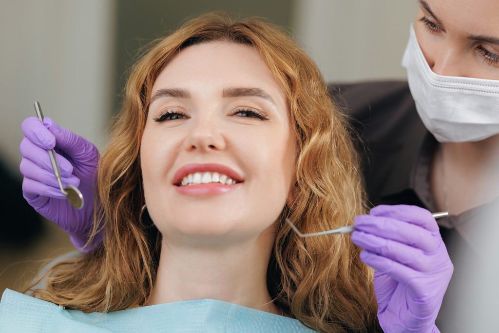 Caucasian,Female,Adult,Patient,Smiling,During,Dental,Checkup,With,Dentist.